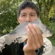 Asian Man Holding Freshwater Drum Catch
