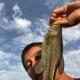 Asian man with catch of Largemouth Bass