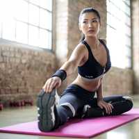 asian-woman-stretching-on-mat