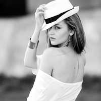beautiful-young-lady-in-white-backless-shirt-and-hat