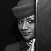 black-woman-wearing-a-hat-behind-door