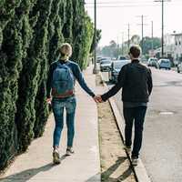 boy-girl-holding-hands-on-the-sidewalk
