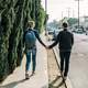 boy-girl-holding-hands-on-the-sidewalk