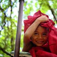 child-with-red-textile-covering