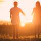 couple-holding-hands-sunset