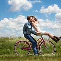 couple-romancing-on-pink-bike