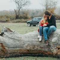 couple-snuggling-on-a-log