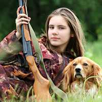 cute-female-hunter-with-rifle-fun-and-dog