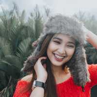 cute-girl-in-fur-cap-smiling