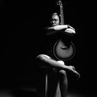 Dark Room Shot of Guitar Player