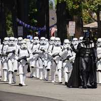 Darth Vader and storm troopers marching in parade
