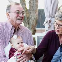 elderly-couple-holding-grandkids