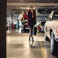 fashionable-woman-walking-towards-car