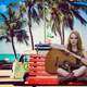 female-guitar-player-sitting-on-bench