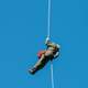 Veteran wildland firefighter rappellers use various techniques to negotiate the wind from the helicopter rotor blades above them, and away from tree branches, beside and below, as they perform a controlled and safe rappel, during the U.S. Department of Agriculture (USDA), U.S. Forest Service (USFS) National Helicopter Rappel Program’s Rappel Academy at Salmon Air Base, in Salmon, Idaho, Thursday, May 15, 2014. This will enable graduates to operating in various roles of helibase operations and as aerially delivered firefighters.  During the week of May 12 there will be 72 veteran rappellers from all over the nation, along with 30 additional support staff and three helicopters with flight crews coming to Salmon.  The training will take place at the Salmon Air Base and participants will rappel into the Perreau Creek area. The annual training is delivered in accordance with the National Rappel Operations Guide; strengthen leadership, teamwork, and communications within the rappel community, and produces quality aerial delivered firefighters for use in fire and aviation operations.  The USDA Forest Service National Helicopter Rappel Program’s primary mission is initial attack.  Rappel crews may be utilized for large fire support, all hazard incident operations, and resource management objectives. USDA Photo by Lance Cheung.