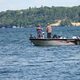 Fisherman on boat in middle of lake