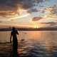 Fishermen casting Net in the Water