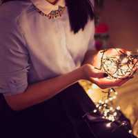 girl-holds-christmas-lights