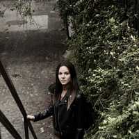 girl-in-black-leather-jacket-at-bottom-of-stairs