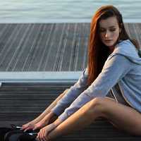 girl-in-gray-hoodie-sitting-on-the-dock