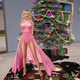 girl-in-pink-dress-next-to-christmas-tree