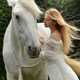 Girl in white dress with long hair with white horse