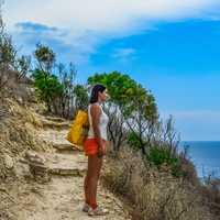 girl-looking-at-ocean-from-mountain-hiking-path