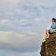 Girl sitting on a rock ledge