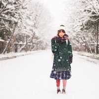 girl-standing-out-in-the-failing-snow