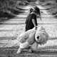 Girl walking giant teddy bear