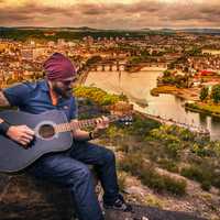 guitarist-playing-while-overlooking-city