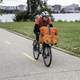 man-carrying-packages-on-a-bike-on-a-bike-path