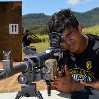 Man looking through the scope on a sniper gun