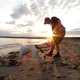 Man playing on beach with dog