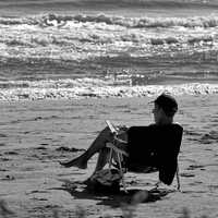Man sitting on the beach monochrome