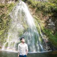 man-standing-at-a-waterfall