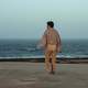 man-walking-on-the-beach-towards-shore