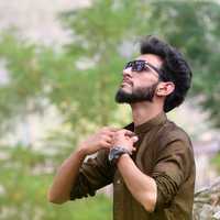 man-wearing-brown-collared-shirt-and-sunglasses