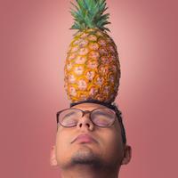Man with pineapple on head