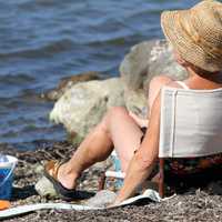 old-woman-sitting-on-the-beach