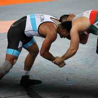 People wrestling in a match