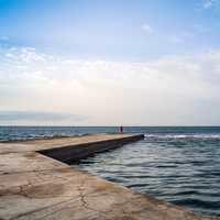 Person standing on the end of the pier