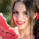 Pretty young woman eating watermelon