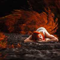 red-haired-girl-lying-on-the-ground