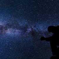 silhouette-of-a-man-under-the-stars-and-galaxy