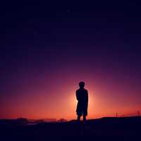 silhouette-of-boy-standing-at-the-end-of-dusk