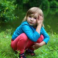 small-girl-crouching-in-the-grass