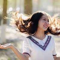 smiling-asian-girl-playing-in-the-wind