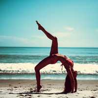 somersault-pose-of-young-women-on-beach