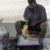 spray-paint-artist-working-with-fire-on-a-piece-of-art